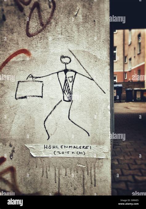 Modern caveman on a wall in Berlin, Germany: businessman stickfigure ...