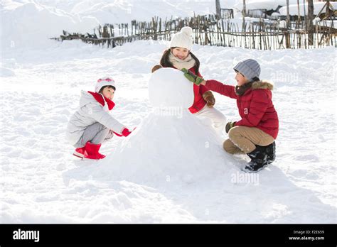 Chinese child making snowman hi-res stock photography and images - Alamy