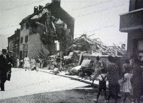 An Old Black And White Photo Of People Walking In Front Of A Building