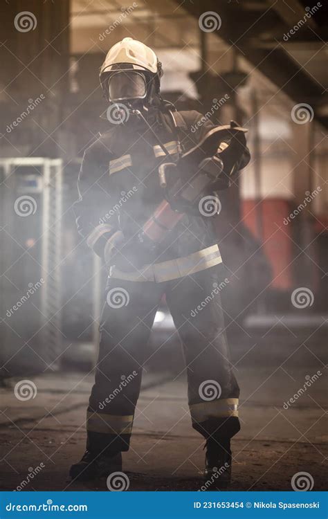 Firefighter Portrait Wearing Full Equipment Oxygen Mask And Emergency