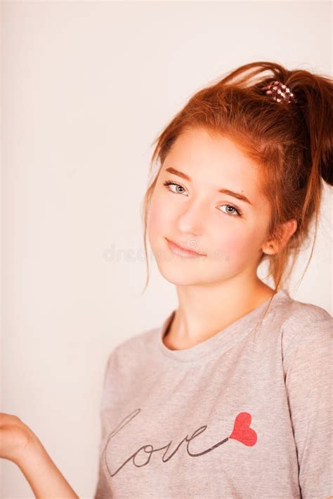 Happy Beautiful Girl Smiling With Closed Eyes Touching Her Red Curly