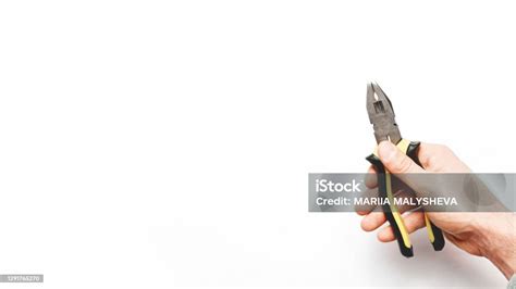 Male Hand Holding Tool Pliers On White Background With Copy Space For