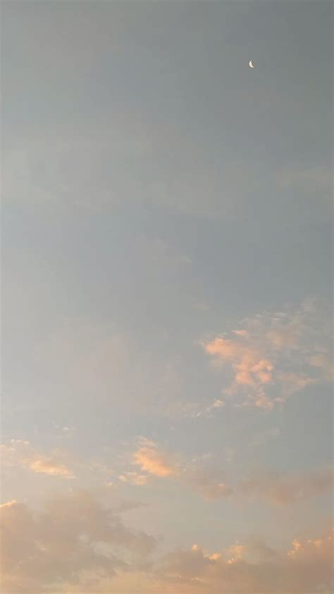 Two People Standing On The Beach Watching The Sun Go Down And One