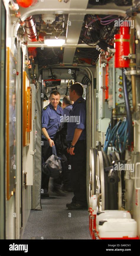 Crew Members Pass In A Narrow Corridor Aboard The Royal Navy S Newest