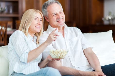 Premium Photo Couple Eating Pop Corn And Watching Tv