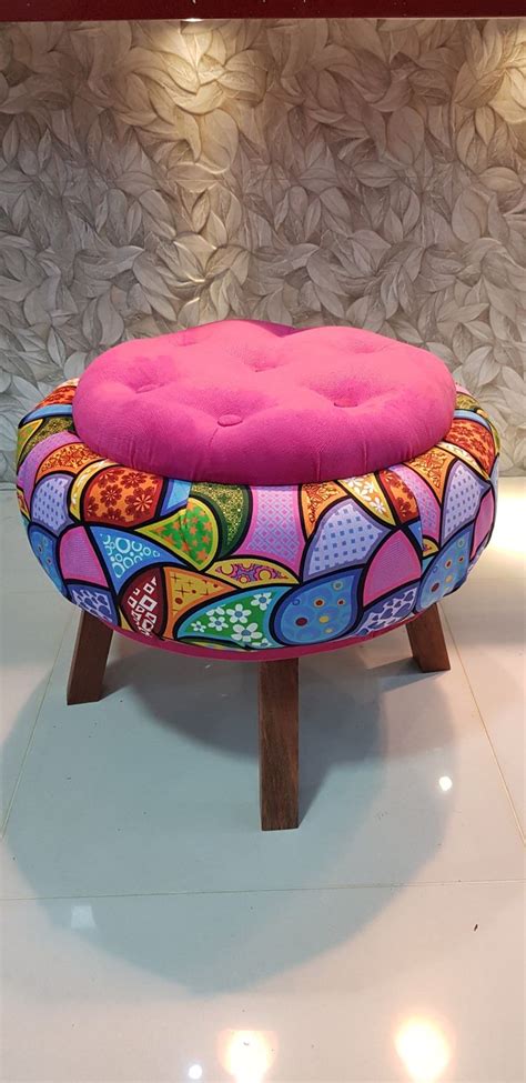 A Brightly Colored Ottoman Sitting On Top Of A White Tile Floor Next To