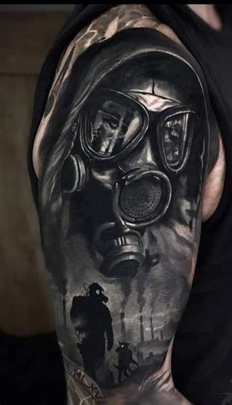 A Man With A Gas Mask Tattoo On His Arm And Shoulder Is Shown In Black