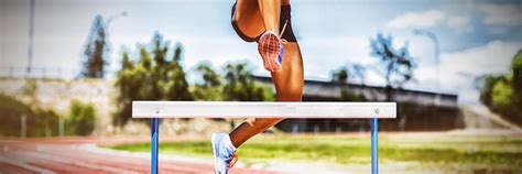 Premium Photo Female Athlete Jumping Above The Hurdle