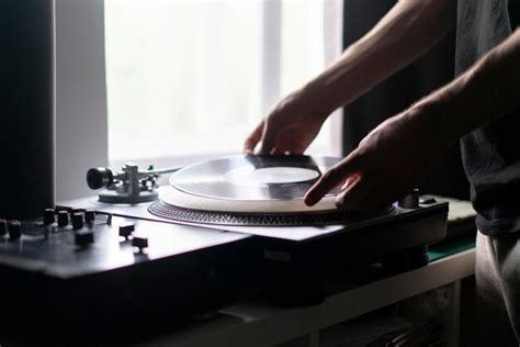 Premium Photo Man Changing Record On Vinyl Player