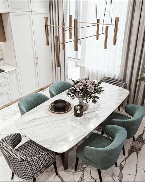 A Marble Dining Table Surrounded By Blue Chairs