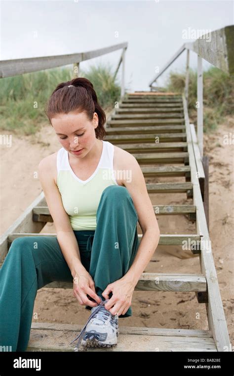 A Woman Tying Her Shoelace Sweden Stock Photo Alamy