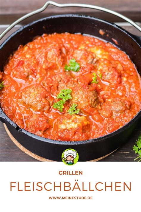 A Skillet Filled With Meatballs And Sauce On Top Of A Wooden Table Next