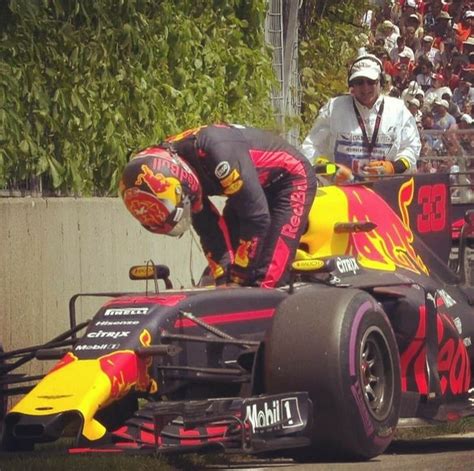 A Red And Yellow Race Car Being Worked On By Two Men In Front Of It