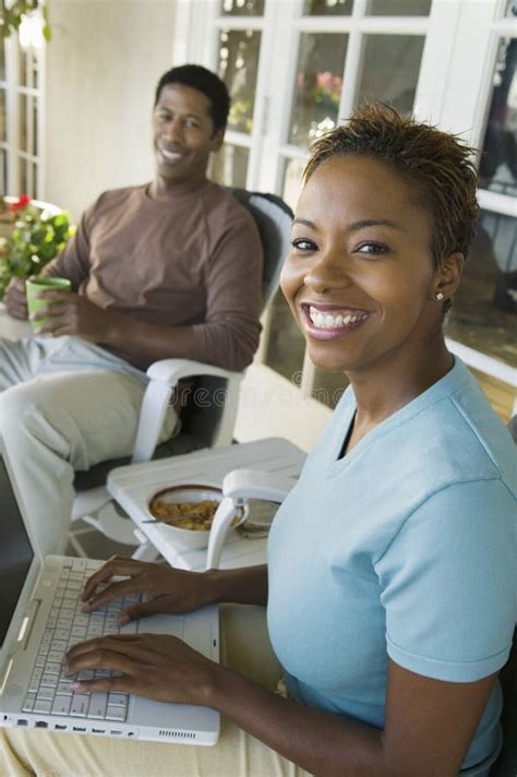 Mujer Que Usa La Computadora Port Til Marido En Fondo Imagen De