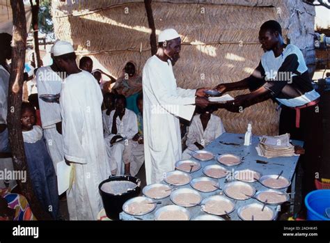 Malnourished man. View of a malnourished man being given high-energy porridge. He, and the other ...