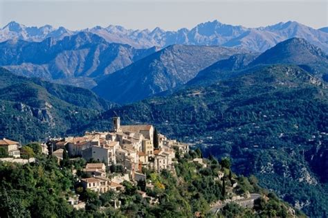 An Old Village Nestled On Top Of A Mountain With Mountains In The Backgroud