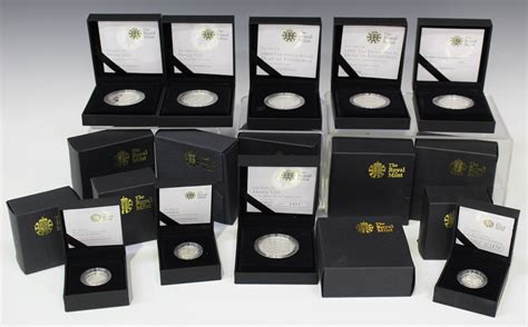 A collection of Royal Mint commemorative coins, including a 'Henry VIII ...