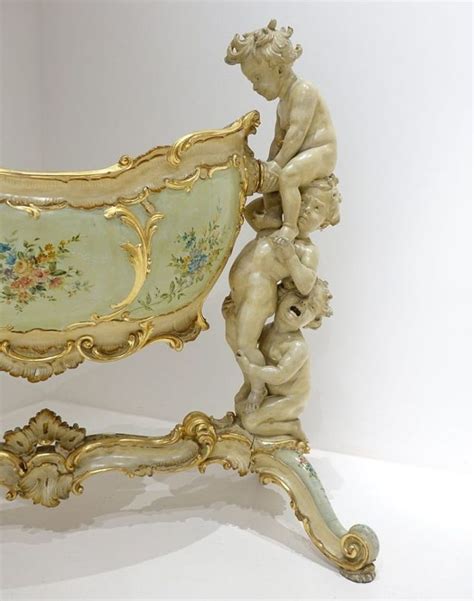 An Ornately Decorated Bench With Cherubs On It