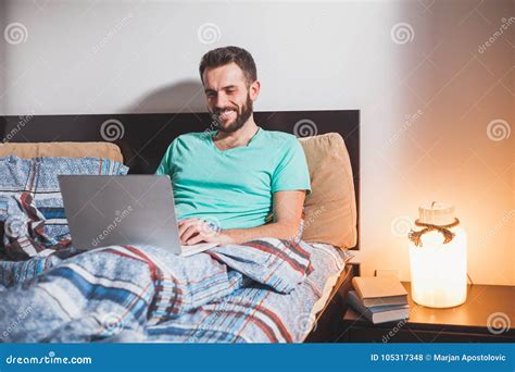 Young Man Working on a Laptop in Bed Stock Photo - Image of internet ...