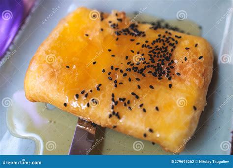 Fried Feta Cheese Wrapped In Phyllo Pastry With Honey And Sesame