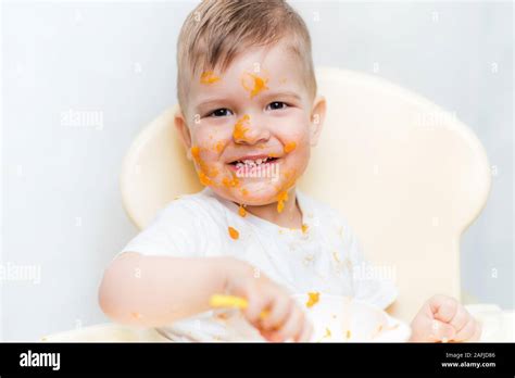 Cute Boy During A Meal Smeared His Face With A Pumpkin Stock Photo Alamy