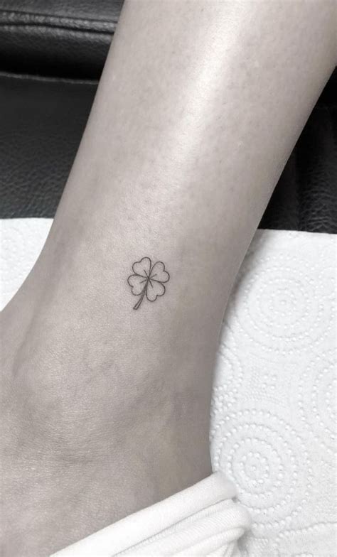 a small four leaf clover tattoo on the ankle