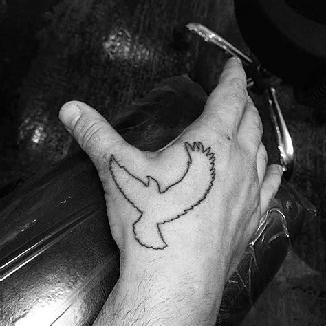 Minimalistic eagle tattoo located on the hand.