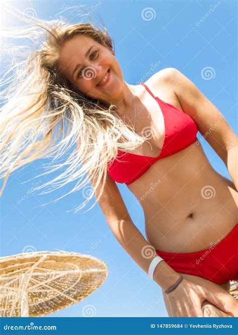 Portrait Of Beautiful Smiling Young Woman With Long Hair Wearing Red