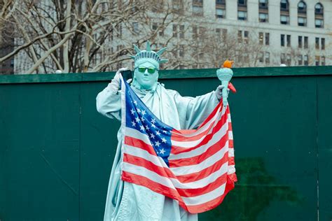 A statue of liberty holding an american flag photo – Free New york ...