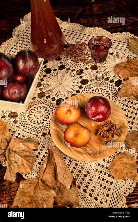 Homemade Plum Brandy And Ingredients In An Autumnal Setting Stock Photo