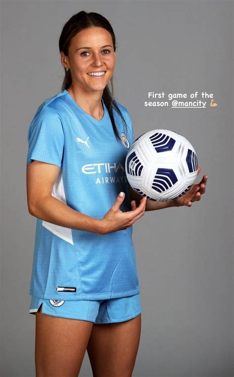 A Woman Holding A Soccer Ball In Her Hands