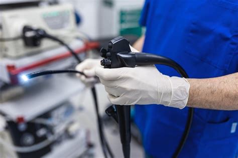 Premium Photo Doctor Proctologist Holding Endoscope During Colonoscopy Probe Colonoscope