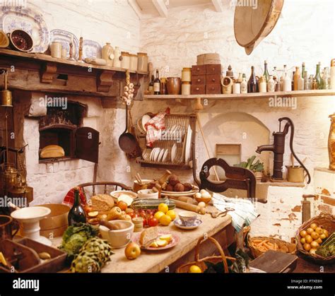 Table laden with food in cluttered old fashioned kitchen Stock Photo ...