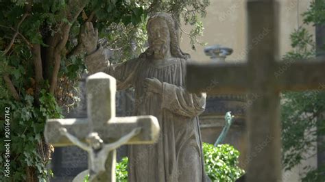 Jesus Christ statue and tombstones Stock Video | Adobe Stock