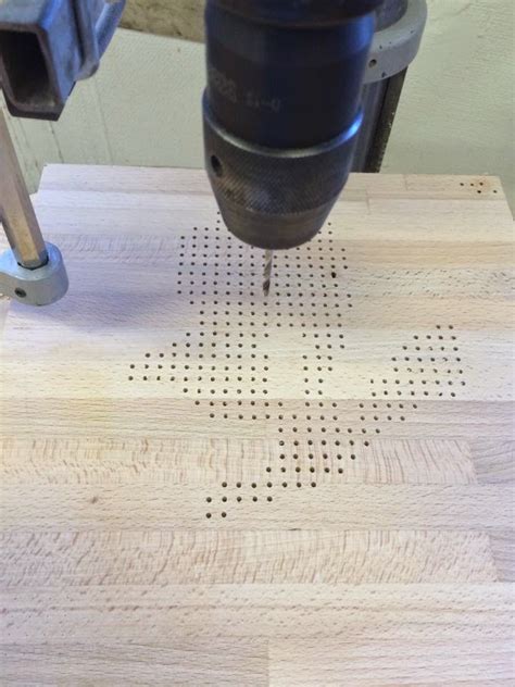 A Drill Is Being Used To Make Holes In Wood