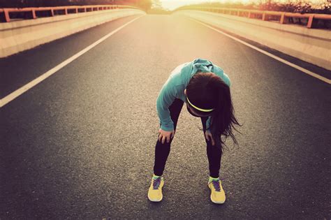 Tired Woman Runner Taking A Rest After Running Hard On City Road