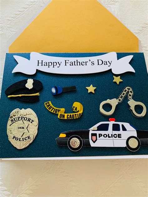 a father's day card with police badges, handcuffs, and badge on it