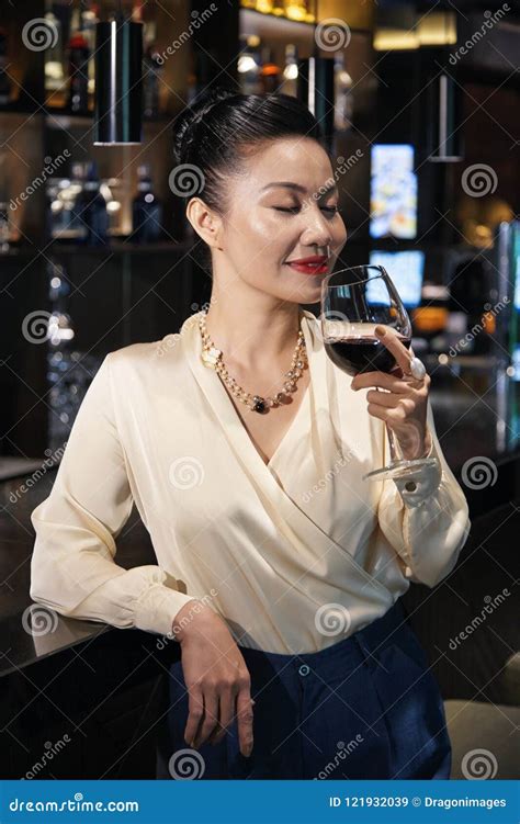 Businesswoman With Wine Leaning On Bar Counter Stock Image Image Of