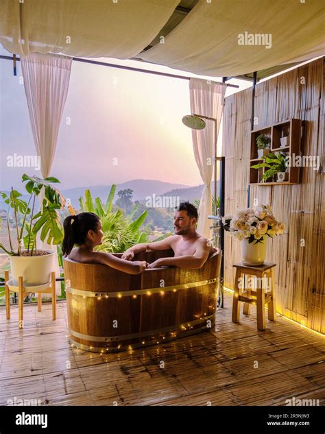 A Couple Of Men And Women In A Bath Tub In The Evening During Sunset Couple In Bathtub Stock