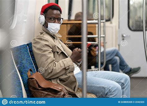 Young African American Man In Glasses Sitting In Subway Train Wear Face