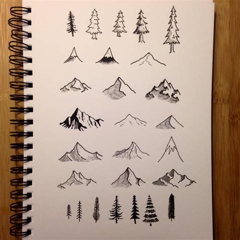 a notebook with drawings of mountains and trees