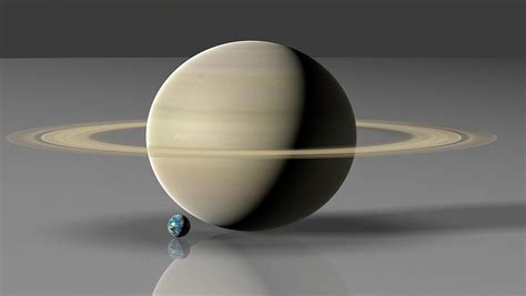 Earth Compared To Saturn Photograph by Mark Garlick/science Photo ...