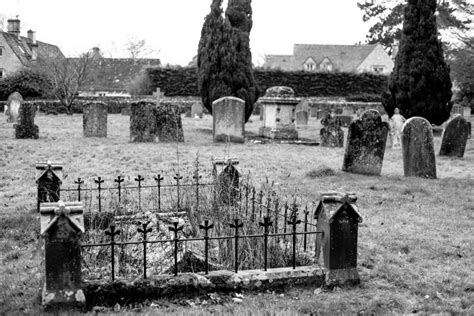 Historic Tombs And Yew Trees In The Churchyard At Painswick England