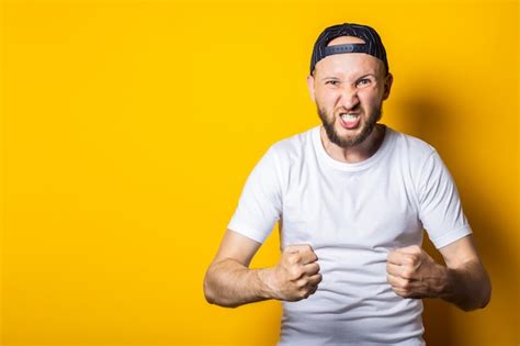 Premium Photo Young Man With A Beard With Clenched Fists Showing