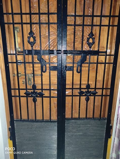 Iron Gate With Wooden Panels And Glass