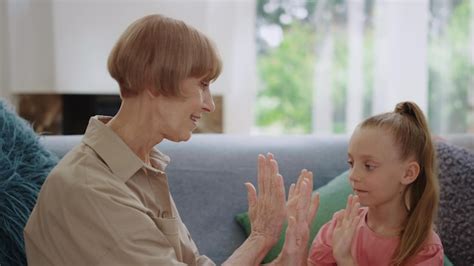 Premium Photo Happy Grandmother And Granddaughter Playing Patty Cake