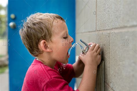 Kid Drinking Water From Fountain