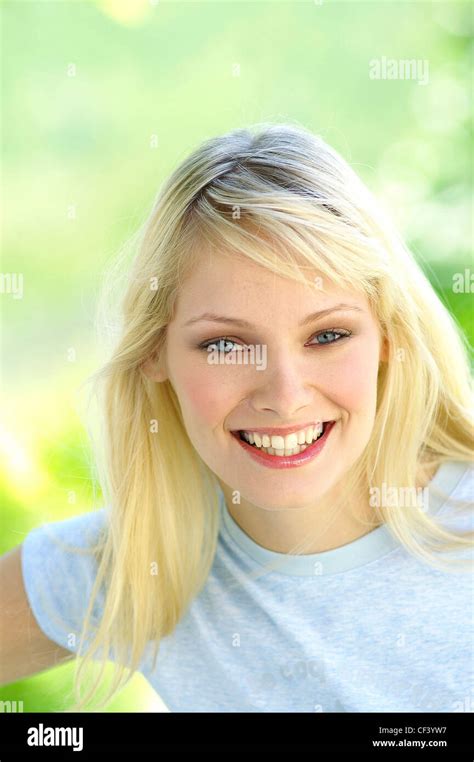 Female With Long Straight Blonde Hair Wearing Pale Blue T Shirt Looking