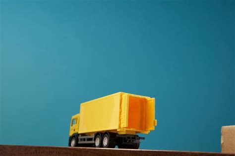 Premium Photo Yellow Container Truck Against Blue Background