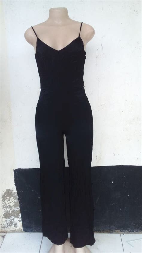 A Mannequin Wearing A Black Jumpsuit On Display